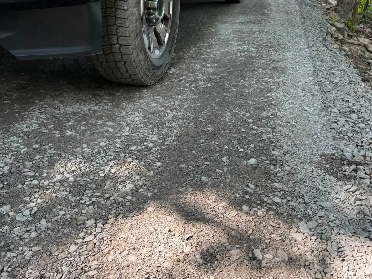 Close view of a freshly graded crushed stone gravel driveway surface