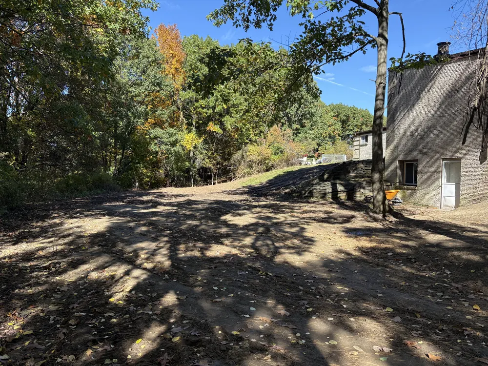Land grading of a backyard, soil leveled and smoothed beside the house